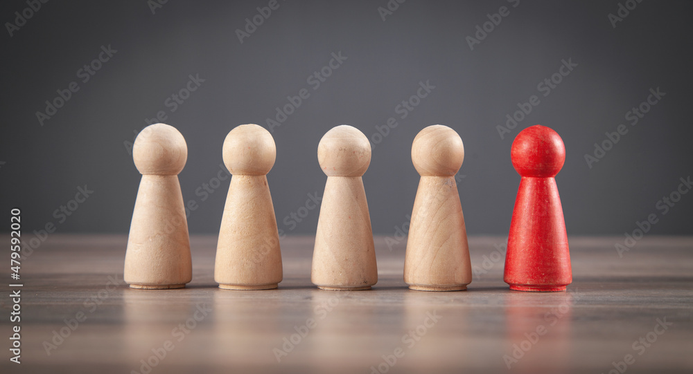 Wooden human figures on the desk. Leader Wooden human figures on the desk. Leader