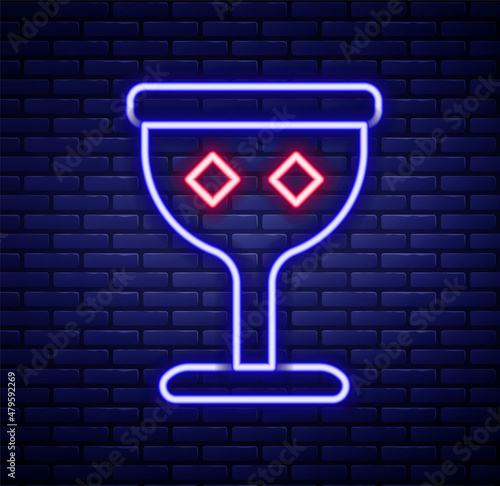 Glowing neon line Medieval goblet icon isolated on brick wall background. Holy grail. Colorful outline concept. Vector