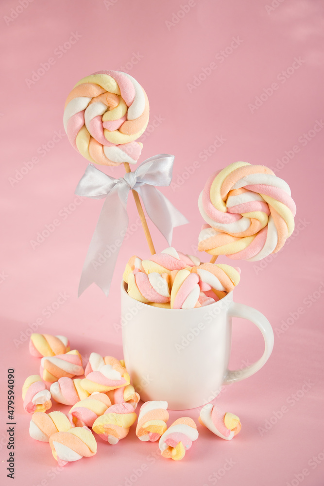 Sweet marshmallows on a pink pastel background. Childhood and birthday concept.