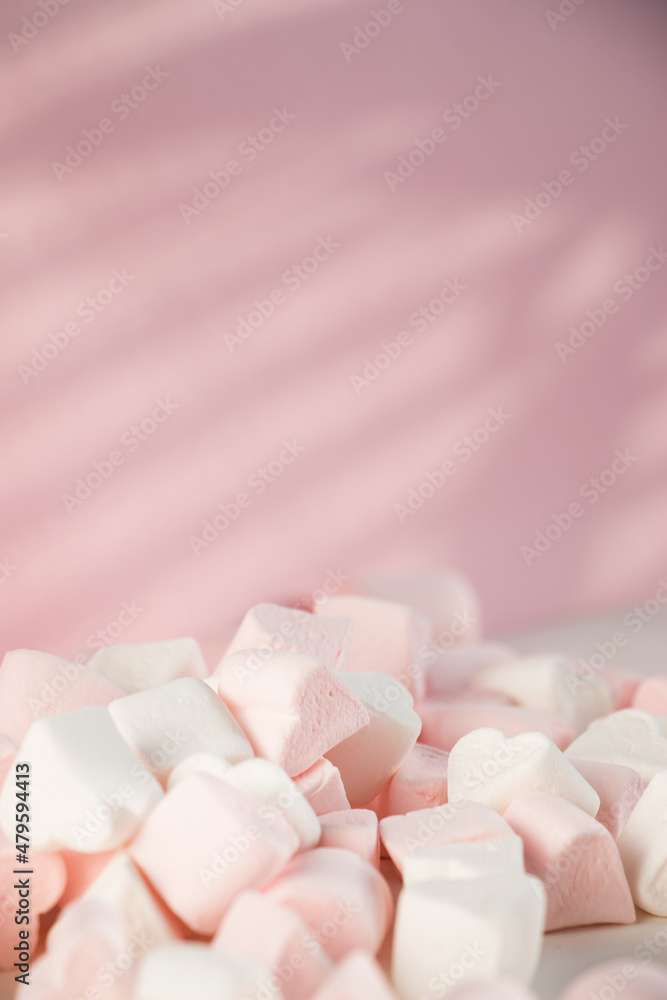 Sweet marshmallows on a pink pastel background. Childhood and birthday concept. Sweet marshmallows on a pink pastel background. Childhood and birthday concept.