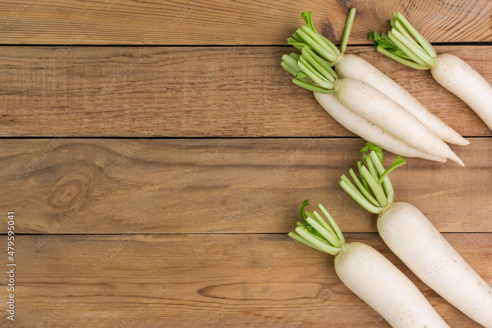 white radish on rustic wooden table with copy space - top view white radish on rustic wooden table with copy space - top view