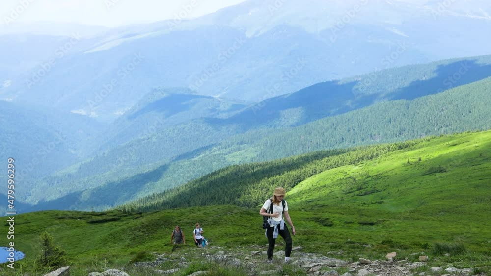 Successful traveler hiking girl with backpacks. Hiking in mountains, healthy active lifestyle. Successful traveler hiking girl with backpacks. Hiking in mountains, healthy active lifestyle.