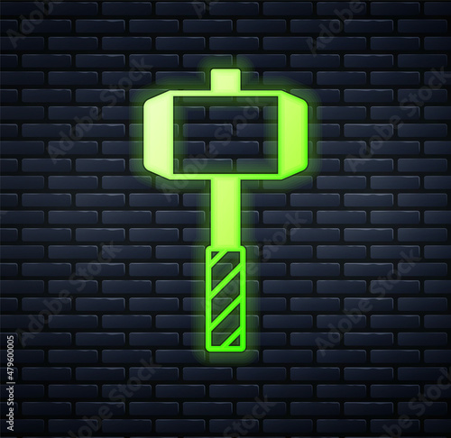 Glowing neon Medieval battle hammer icon isolated on brick wall background. Vector