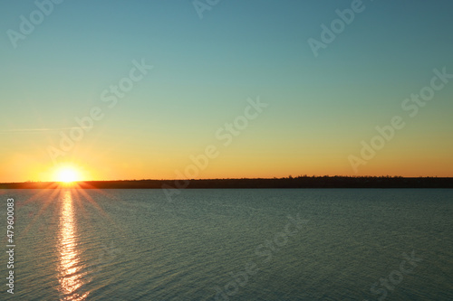 Fototapeta Naklejka Na Ścianę i Meble -  Picturesque view of beautiful sunset over calm river