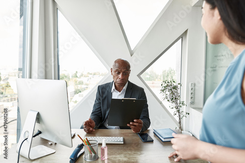 Employee looking on boss reading her report