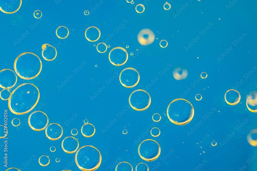Abstract background of bubbles in blue liquid.