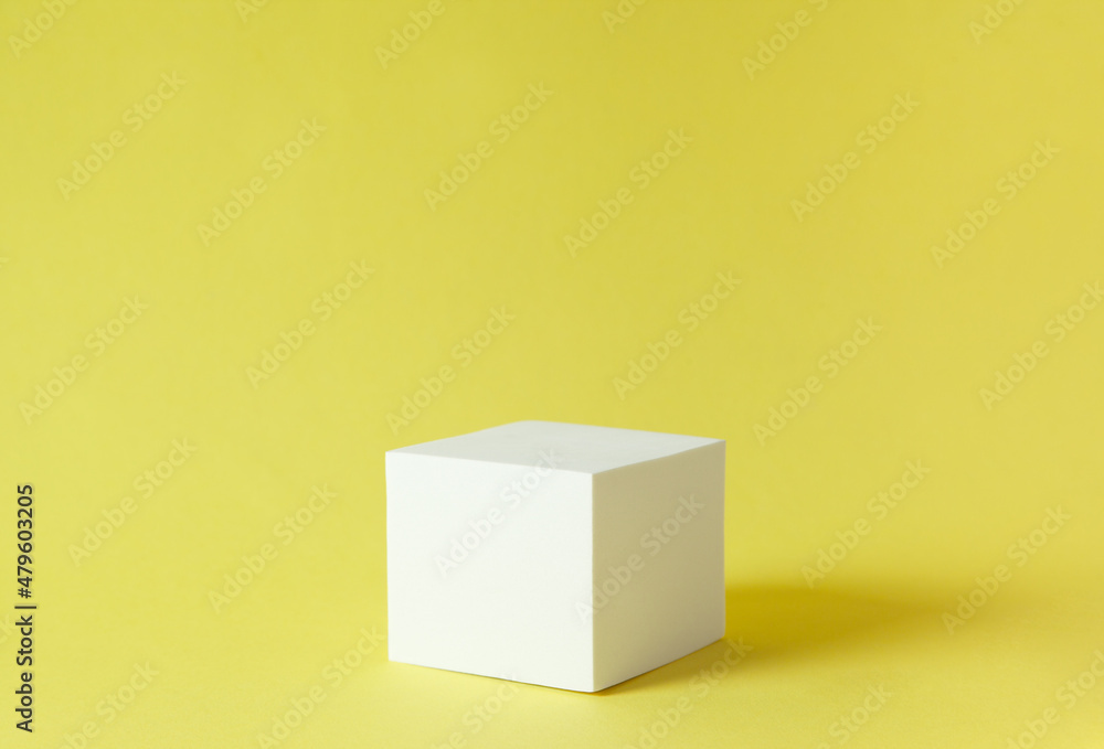 white cube on yellow background white cube on yellow background