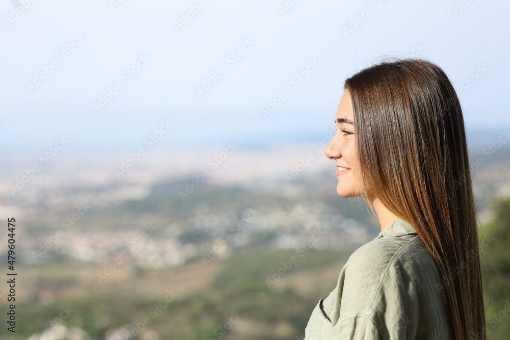Happy teen contemplating views outdoors