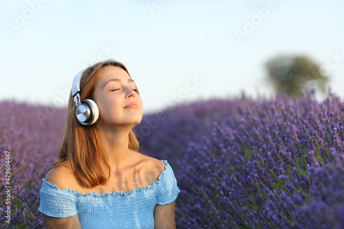 Female breathing listening to music in a lavender field photo