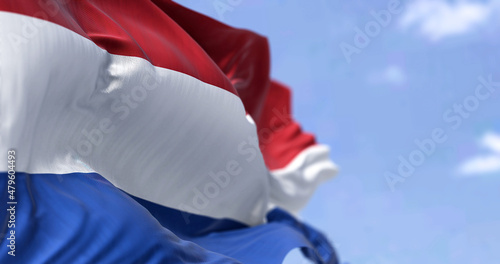 Detail of the national flag of the Netherlands waving in the wind on a clear day