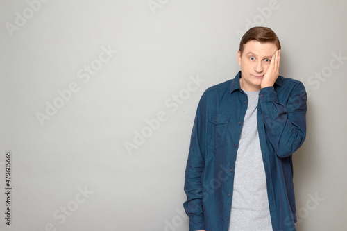 Portrait of disappointed mature man making facepalm gesture