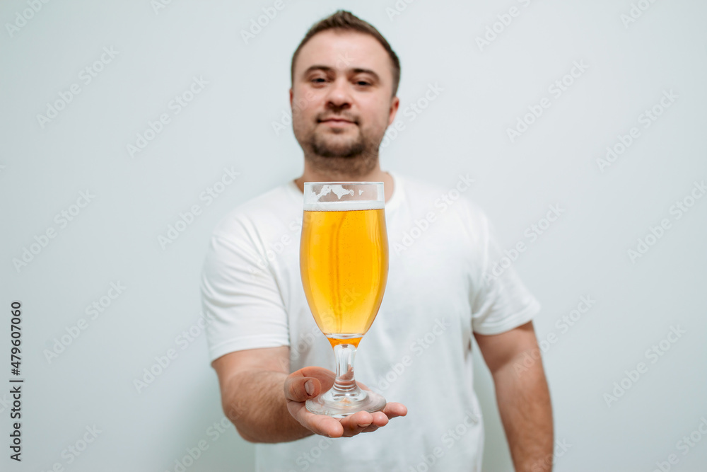 Positive bearded fat guy with a big glass of beer and smiling. Funny young man feeling happy and relaxed, with cold fresh beer in his hands after a hard day at work Positive bearded fat guy with a big glass of beer and smiling. Funny young man feeling happy and relaxed, with cold fresh beer in his hands after a hard day at work