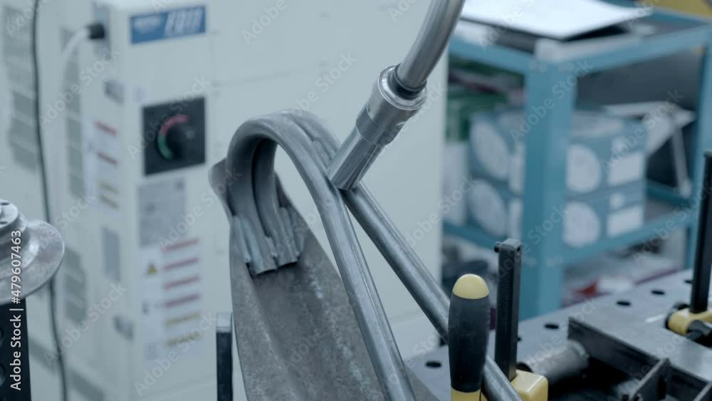 An industrial welding robot demonstrates how the welding of parts fixed on the welding table will take place An industrial welding robot demonstrates how the welding of parts fixed on the welding table will take place