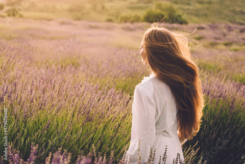 фотографія Woman with Flying Hair in Lavender Field on Sunset