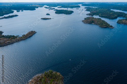 Aerial photography on Ladoga skerries. Ladoga Lake in Karelia in hot summer. Rocky wild islands in the middle of the lake. Russian nature