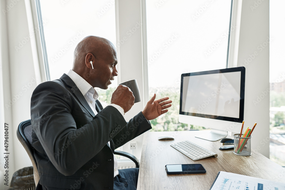 Businessman watching on computer and drinking tea Businessman watching on computer and drinking tea
