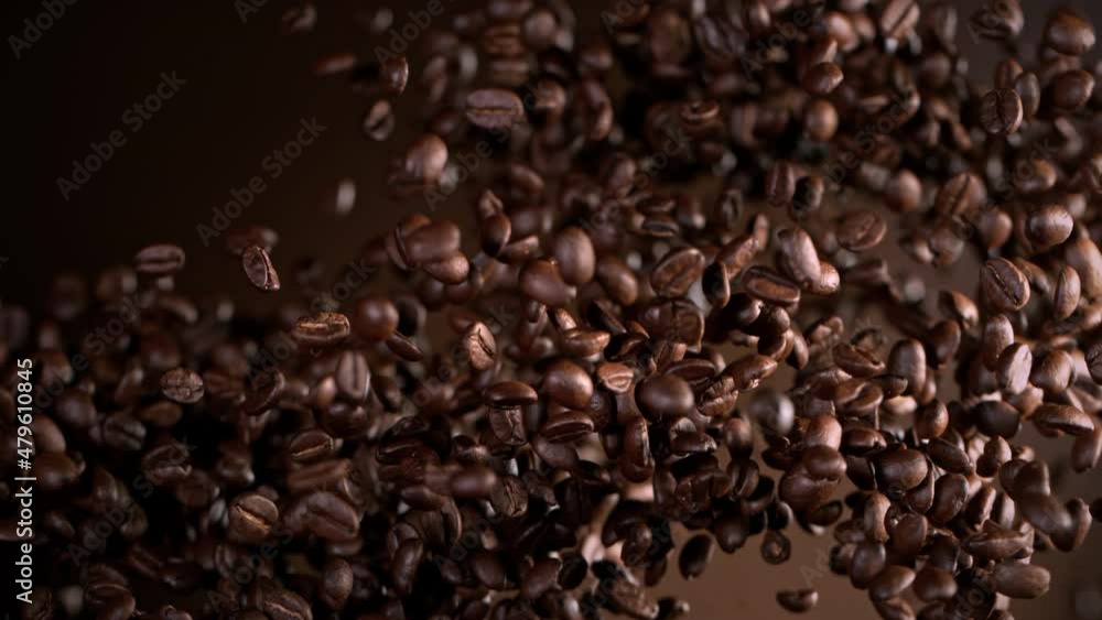 Super Slow Motion Shot of Exploding Premium Coffee Beans on Brown Gradient Background at 1000fps. Super Slow Motion Shot of Exploding Premium Coffee Beans on Brown Gradient Background at 1000fps.