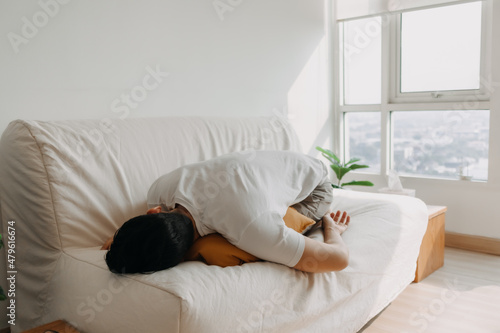 Lonely single sick Asian man sleep and isolated in his apartment.