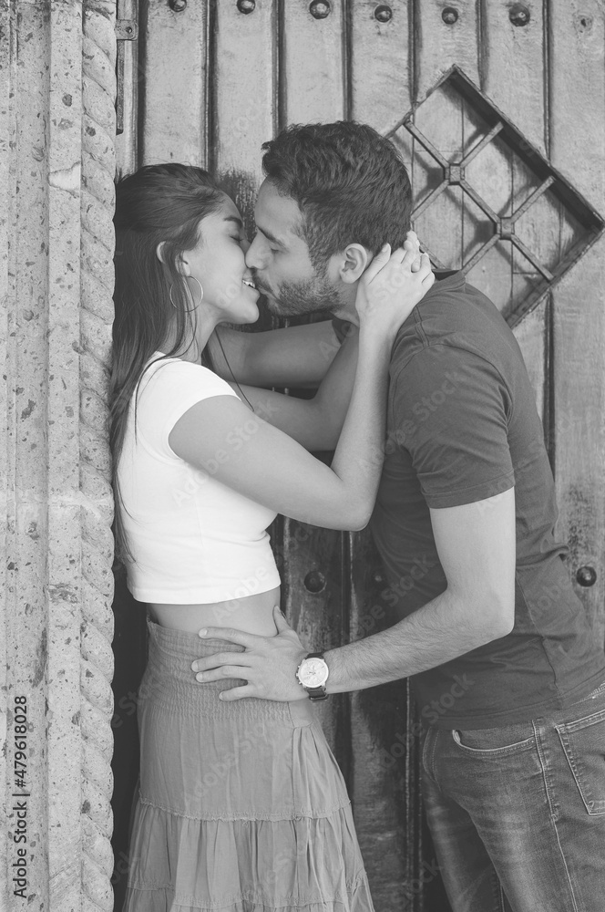 Couple in love outside a rustic house.