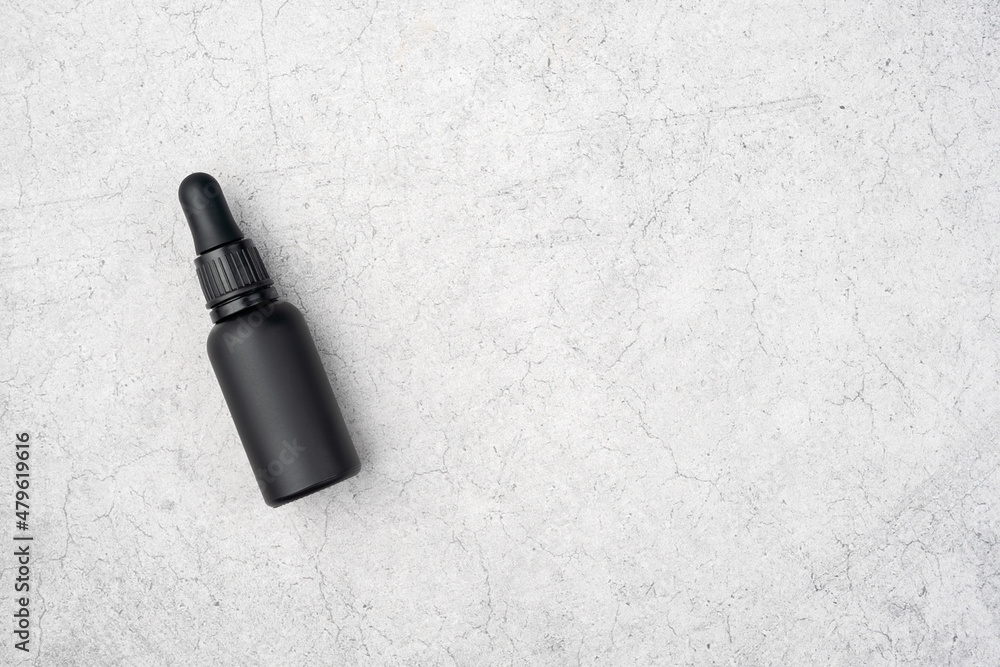 Natural oil for men in a black glass bottle. Beard care. Top view, copy space... Natural oil for men in a black glass bottle. Beard care. Top view, copy space...
