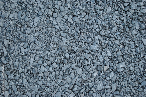 Gravel path in the park. Fine pebbles. An alley in the garden. An interesting pattern for wallpaper, background.