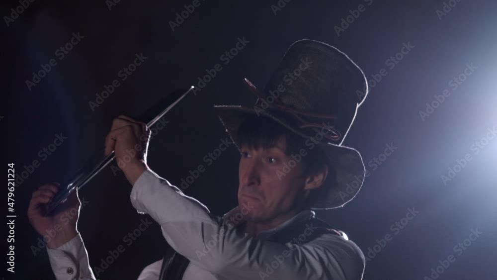 Steampunk. A male alchemist in a retro hat closes with a tray. Frozen flowers hit the tray. Flowers break and fly apart. Steam is spreading around. Show, performance Steampunk. A male alchemist in a retro hat closes with a tray. Frozen flowers hit the tray. Flowers break and fly apart. Steam is spreading around. Show, performance