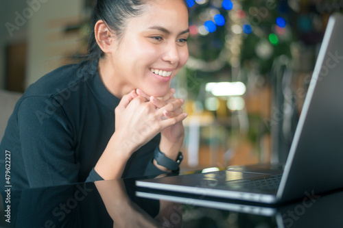 A young happy woman is surprising while using computer laptop in cafe. people and technology concept...