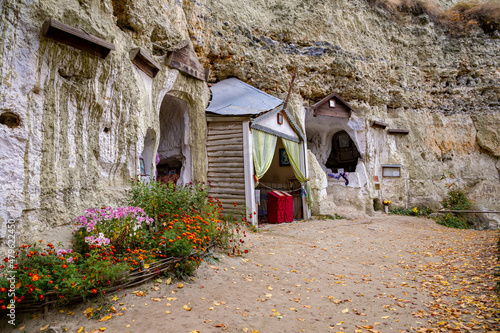 Cave monastery on Bakota over the Dniester river in autumn day.