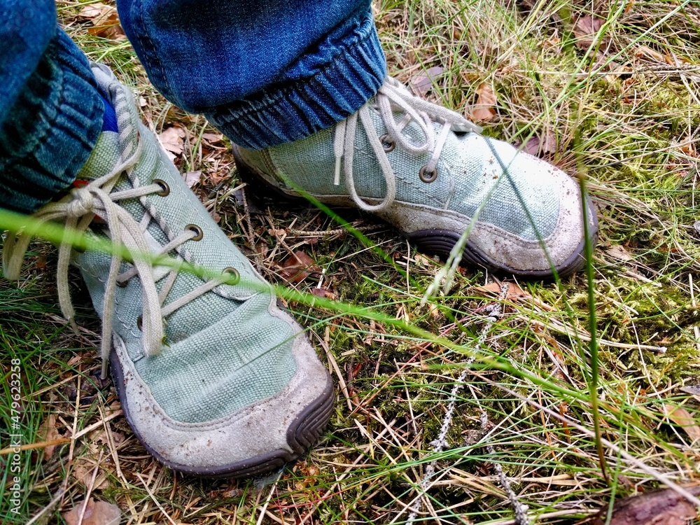 Child hiking with barefoot shoes in the forest Child hiking with barefoot shoes in the forest