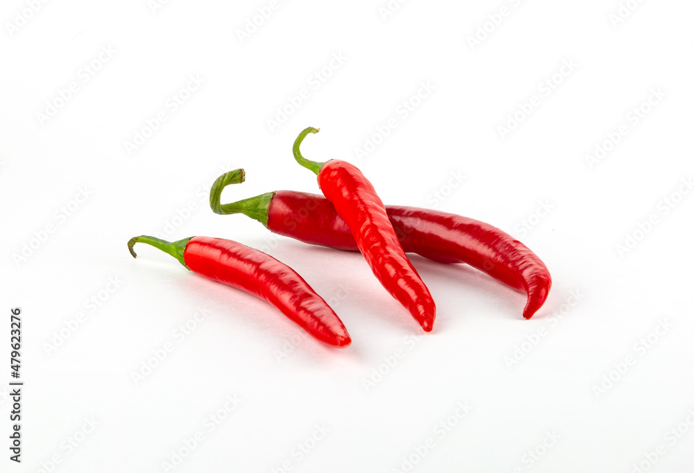 Three red chili peppers isolated on white background.