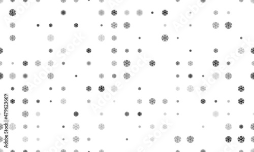 Seamless background pattern of evenly spaced black snowflake symbols of different sizes and opacity. Vector illustration on white background