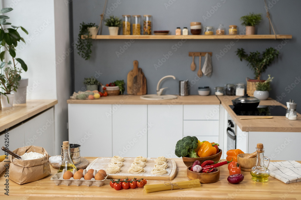 Wooden kitchen table with fresh ingredients for dough, traditional italian pasta and homemade pastry Wooden kitchen table with fresh ingredients for dough, traditional italian pasta and homemade pastry