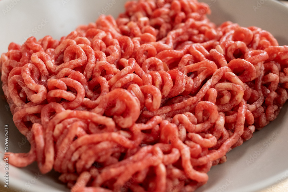 Minced beef or pork in white porcelain bowl prepared for cooking traditional italian pasta with meat or homemade pastry Minced beef or pork in white porcelain bowl prepared for cooking traditional italian pasta with meat or homemade pastry