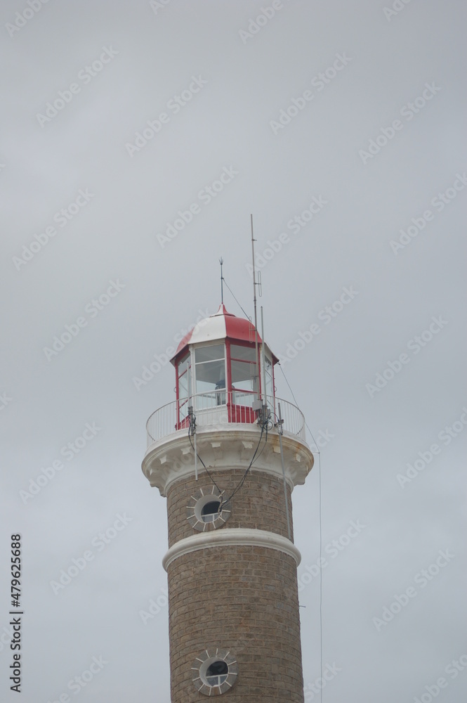 Lighthouse on the coast against a grey stormy sky