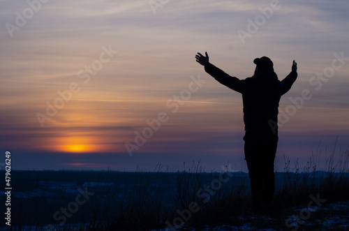 Prayer. Repentance. A man with his hands raised against the sky. Pray to God. Worship