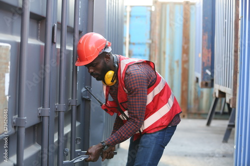 Foreman control loading Containers box from Cargo freight ship for import export. Freight containers in sea port.