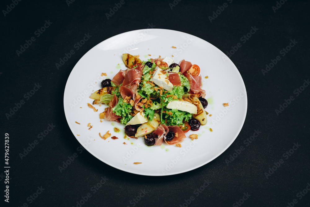 The new dish or salad is made by the professional. The new dish or salad is made by the professional.