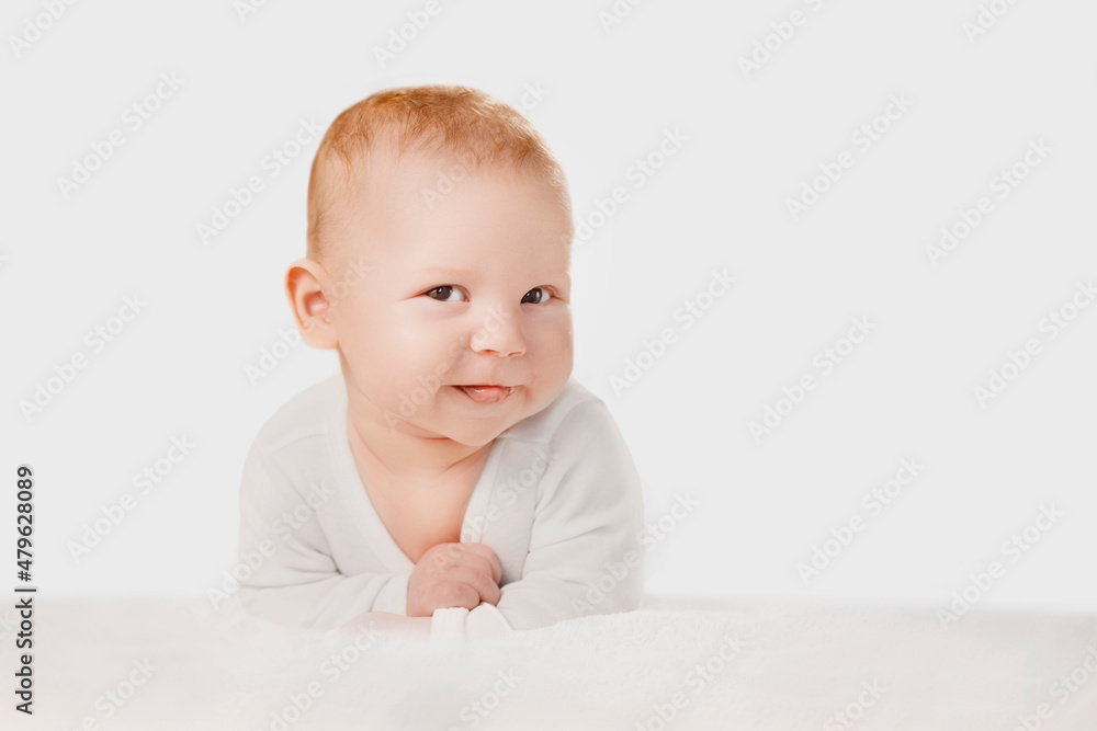 Portrait of smiling cute baby boy or baby girl in nursery. Baby care and childcare concept. Срild is playing, naughty, showing the tongue