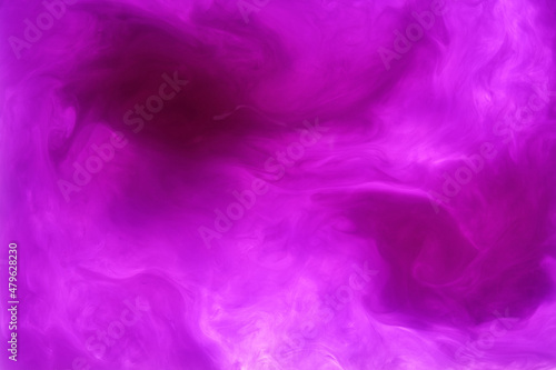 purple acrylic ink making shapes in the water