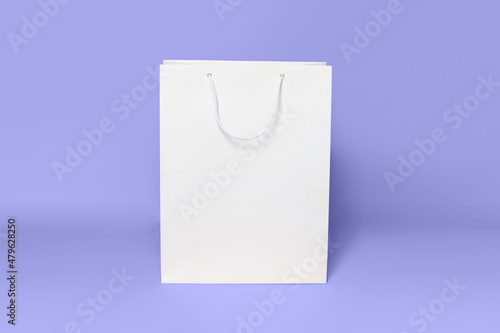 Mockup of white shopping bag isolated over lilac background. color of the year 2022 very peri