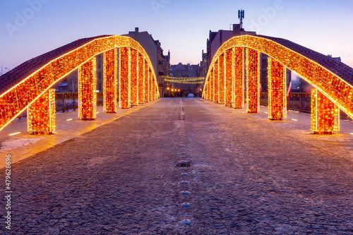 Poznan. The Bishop Jordan Bridge in the early morning festive illumination.