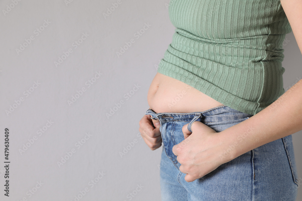 Foto de Woman wearing tight clothes on light grey background