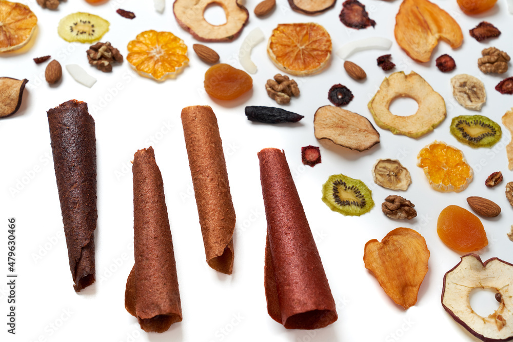 Above view of tasty dried fruits kiwi, orange, apple, persimmon and nuts with delicious fruit lozenge different colors.Concept of healthy assorted dried fruit for snacks. Above view of tasty dried fruits kiwi, orange, apple, persimmon and nuts with delicious fruit lozenge different colors.Concept of healthy assorted dried fruit for snacks.