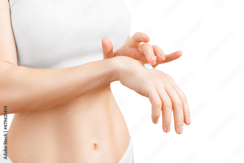 Woman applying cream, female hands, white, closeup.