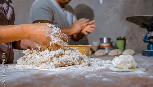 Female hands making dough for artisan bread, bakery concept