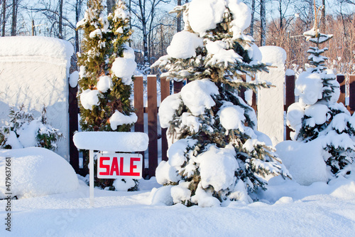 sale sign in winter with snow
