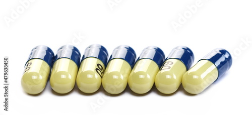 Row pills macro  medicine isolated on white  side view 