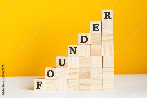 the word founder is written on a wooden cubes, concept