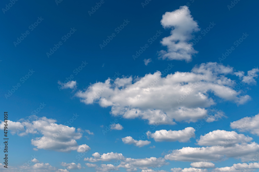 bright blue sky with group of white cumulus clouds as a natural background bright blue sky with group of white cumulus clouds as a natural background