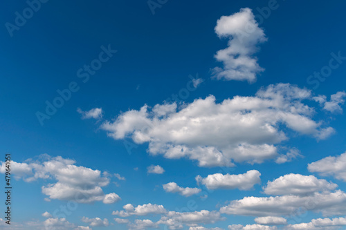 bright blue sky with group of white cumulus clouds as a natural background